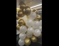 large assortment of gold and white balloons
