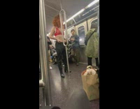 a man with red bra and red wig