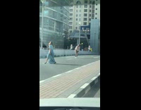 Woman blue dress walk middle of road