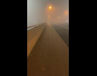 Woman walk on bridge night thick fog