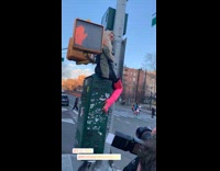 woman pink boots sits street sign