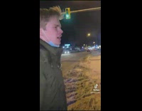 Guy green hoodie jacket walking on snow sidewalk