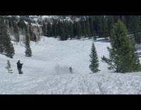 Guy on snowmobile makes jump over ramp