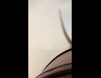 Personal plane flies through white cloud 