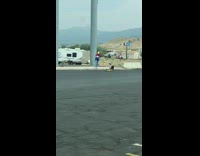Yellow beanie girl kicks air sidewalk pose