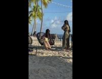 ﻿Woman in stripes dress sits on the beach chair