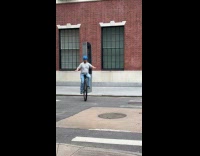 Man blue helmet ride unicycle on street