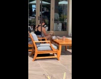 Woman films dog eats food outside store