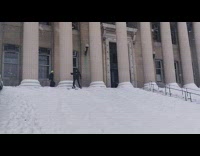Guy on skis tries to ski down snow covered stairs 