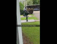 Guy uses outdoor exercise leg machine 