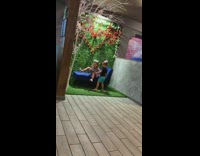 Little girl on blue chair selfie brother