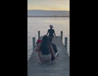 Guy brim hat black shirt sit pier