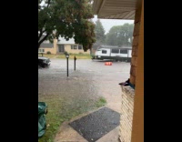 Traffic cones floating in flood on street
