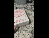 Hot dog between mac and cheese box 