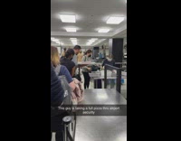 Guy holds box pizza at the security in airport NY 