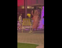 Woman in bikini poses by the fountain near the kids