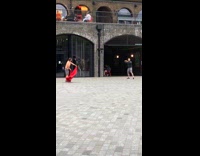 Guy wave spin red cloth outside store
