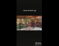 Three people dance in middle of dance floor 