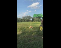 Guy backflip green construction vehicle pond water