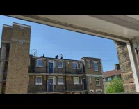 Guy white shirt sing music video rooftop