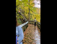 Woman waits for man poses at bridge