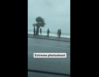 Three girls dresses side of road windy