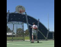 Guy shoots basketball into hoop from shoulders 