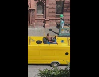 Guy does work with laptop on top of van 