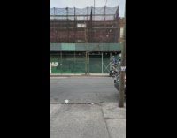 Guy rides tall unicycle