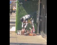 Man with stolen bags rips off tags on street