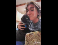 Black cat slips getting close to girls face 