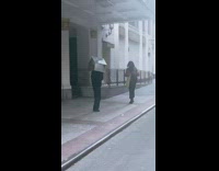 Guy wears shiny foil house over head 