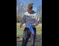 Woman drinks beer from nerf gun 