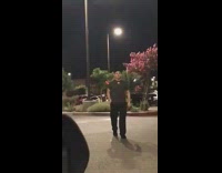 Guy walking towards car playing music Usher Yeah