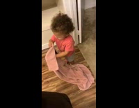 Little girl pink shirt and blanket says she is cold