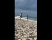 Woman blue bikini dramatic pose beach shore