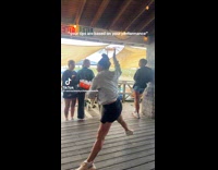 Woman hold drinks tray do cartwheel and leg split