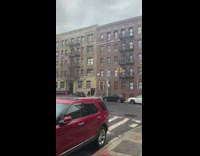 Person drops bags from apartment 