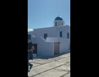 Couple poses on top of the church roof