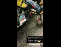 Lady takes rain boots off on subway
