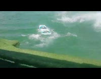 Man wakeboards and gets pulled by boat, flies of board and into the water