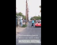Blue shirt guy dances red convertible car