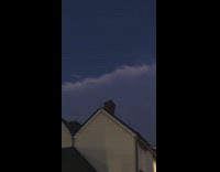 Long straight cut cloud formation afternoon houses