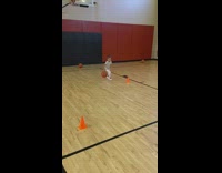 Little girl practices dribbling basketball 