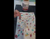 Brown dog eats and paints on canvas 