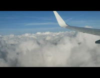 Plane shadow with halo on clouds flight