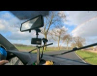 Person in car films beginning of rainbow