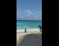 Woman printed swimsuit kneel beach strong waves