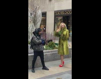 Guy interrupts lady posing for photos christmas  