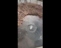 Guy throws huge brick rock off of bridge into icy water 